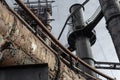 Array of riveted pipes and smokestacks, catwalks and ladders of industrial site Royalty Free Stock Photo