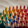 An array of sharpened colored pencils arranged in a closely packed, triangular Royalty Free Stock Photo