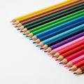 An array of sharpened colored pencils arranged diagonally on a white surface Royalty Free Stock Photo