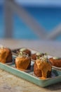 Array of small appetizers with sauce served on the marble table