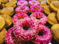 Array of sugar sprinkled doughnut and pink color for background