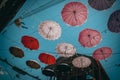 Array of umbrellas suspended in the air above a city street, creating a colorful canopy