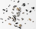 An array of various electronic components and microchips randomly scattered across a clean white surface Royalty Free Stock Photo