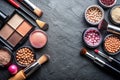 Various makeup products on dark background with copyspace Royalty Free Stock Photo