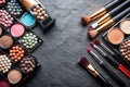 Various makeup products on dark background with copyspace Royalty Free Stock Photo
