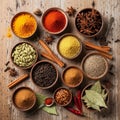 An array of various spices in small wooden bowls on a rustic wooden surface Royalty Free Stock Photo