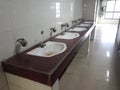 Array of 5 wash basins in a canteen