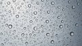 An array of water droplets covers a smooth glass surface creating a Royalty Free Stock Photo