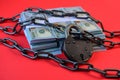 Arrest of bank account or buiness safety and financial protection concept with chain, padlock and dollars Royalty Free Stock Photo