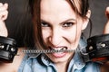 Arrest. Criminal woman prisoner biting handcuffs Royalty Free Stock Photo