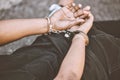 Arrest, justice and thief in handcuffs for fraud, violence and burglary after a suspected house robbery. Law, hands and Royalty Free Stock Photo