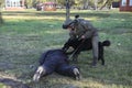 Arrest training. Army dog attacking suspect man wearing protective cloth, man dog handler working, military base Royalty Free Stock Photo