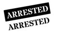 Arrested black rubber stamp on white