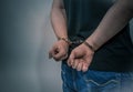 Arrested criminal with handcuffs behind his body concept for crime does not pay Royalty Free Stock Photo