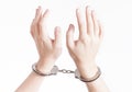 Arrested criminal hands in handcuffs