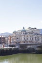 The Arriaga theater next to Nervion river on a sunny day.