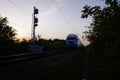 Arrival of a passenger train in the evening, summer sunset view.