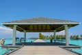 Arrival pier with a roof at the tropical island Royalty Free Stock Photo