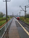 Arrival of the train at the old train station in the rain