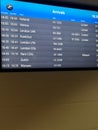 Arrivals display board at airport terminal showing international destinations flights to some of the world`s most popular cities Royalty Free Stock Photo