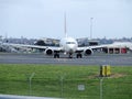 Arriving passenger plane taxiing at the airport Royalty Free Stock Photo