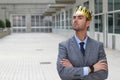 Arrogant businessman with a crown in office space Royalty Free Stock Photo