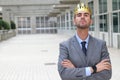 Arrogant businessman with a crown in office space Royalty Free Stock Photo