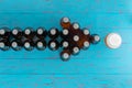 Arrow of beer bottles pointing to a full glass Royalty Free Stock Photo