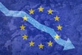 Arrow down on the background of the EU flag. The concept of economic recession, depression and crisis.