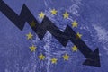 Arrow down on the background of the EU flag. The concept of economic recession, depression and crisis.