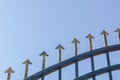 Arrow head iron fence on blue sky