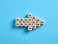 Arrow icon made of wooden cubes with little arrow icons pointing opposite direction. Resistance to change in business Royalty Free Stock Photo