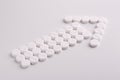 Arrow made of round white medicinal pills. Treatment direction concept Royalty Free Stock Photo