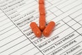 Arrow of orange antibiotic capsules indicates word STDs specified on a sheet of health history. Medications for the treatment of s Royalty Free Stock Photo