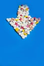 Arrow of pills on a blue background. Royalty Free Stock Photo