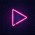 Arrow pink neon on brick wall. Realistic shining signboard. Color neon banner. Glowing arrow pointer icon. Night bright