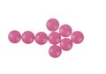 Arrow of pink pills on white background Royalty Free Stock Photo