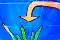 Arrow pointed down on a wall painted blue