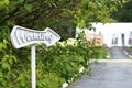 Arrow pointer with wedding text on green foliage background. The road leading to the wedding tent. outdoor celebration, field Royalty Free Stock Photo