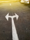 Arrow pointing left and right on ground in a car park Royalty Free Stock Photo