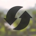 Arrow recycling icon on blurred background
