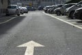 Arrow road sign (marking on the ground) with big negative space within the blurry background