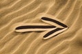 Arrow sign in the sand