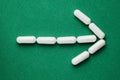 Arrow sign of white capsules pills