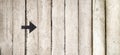 Arrow sign on wooden background. Black sign of arrow on wooden boards. Vintage style of wooden boards background with