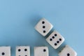 Arrow up. White gaming dices on light blue background. victory chance and lucky. Flat lay style, place for text. Top view and