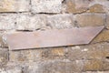 Arrow wooden sign hanging on a rustic brick wall. Emty space, add text