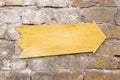 Arrow wooden sign hanging on a rustic brick wall. Emty space, add text