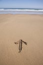 Arrow written in sand beach