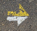 Arrow in yellow and white on a paveway for orientation Royalty Free Stock Photo